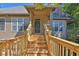 Home entrance featuring a charming covered porch and wooden stairs at 305 Mill Pond Se Ct, Smyrna, GA 30082