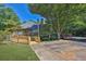 Charming single-story home with inviting walkway and mature trees at 305 Mill Pond Se Ct, Smyrna, GA 30082