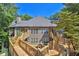 Wonderful view of home exterior with multiple decks and surrounded by lush trees at 305 Mill Pond Se Ct, Smyrna, GA 30082