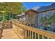 Spacious home featuring an expansive wooden deck and a serene wooded backdrop at 305 Mill Pond Se Ct, Smyrna, GA 30082