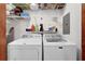 Bright laundry area featuring washer, dryer, and ample shelving for organized storage solutions at 305 Mill Pond Se Ct, Smyrna, GA 30082