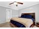 Inviting main bedroom with a ceiling fan, neutral paint, and an open doorway at 305 Mill Pond Se Ct, Smyrna, GA 30082