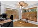 Bright home office with natural light, decorative fan, and bamboo window shades at 305 Mill Pond Se Ct, Smyrna, GA 30082