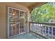 Cozy outdoor patio with a view of the surrounding trees and a sliding glass door at 305 Mill Pond Se Ct, Smyrna, GA 30082