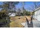 Backyard featuring a shed, trees, a grassy area, and the side of the home and patio at 850 Third St, Stone Mountain, GA 30083