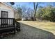The backyard features a small deck, a grassy area, mature trees, and a shed at 850 Third St, Stone Mountain, GA 30083