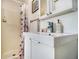 A bathroom features a white cabinet, a shower with a curtain, and basic amenities at 850 Third St, Stone Mountain, GA 30083