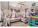 Bright bedroom featuring two beds, plush carpet, a ceiling fan, and lots of natural light at 850 Third St, Stone Mountain, GA 30083