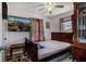 Comfortable bedroom with colorful floor covering, wood furnishings, and two windows at 850 Third St, Stone Mountain, GA 30083