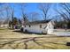 Spacious backyard featuring the side of the home, mature trees, and a shed at 850 Third St, Stone Mountain, GA 30083