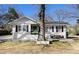 Charming home featuring a brick facade, black shutters, and a cozy front porch sitting area at 850 Third St, Stone Mountain, GA 30083