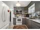 Well-lit kitchen features stainless steel microwave, white oven, gray cabinets, and a decorative backsplash at 850 Third St, Stone Mountain, GA 30083