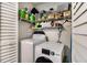 A laundry area shows shelving, cleaning and laundry products, and a washer and dryer at 850 Third St, Stone Mountain, GA 30083