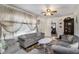 Bright living room featuring neutral furnishings, patterned rug, and a view into other rooms at 850 Third St, Stone Mountain, GA 30083