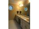 Well-lit bathroom with double sinks, granite countertops, and decorative stained glass window at 3320 Donegal Way, Snellville, GA 30039