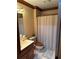 Neutral bathroom features cream walls, a toilet, and a decorative shower curtain at 3320 Donegal Way, Snellville, GA 30039