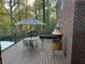 A wooden deck with table, chairs, and grill, offering an ideal spot for outdoor dining at 3320 Donegal Way, Snellville, GA 30039