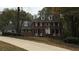Classic brick home with symmetrical windows and dormers, set back on a gently sloping lawn at 3320 Donegal Way, Snellville, GA 30039