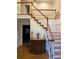 Inviting foyer with classic staircase, wooden floors, and stylish decor creates a warm welcome at 3320 Donegal Way, Snellville, GA 30039