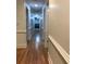 Hallway with hardwood floors, neutral walls, and views into a bedroom at 3320 Donegal Way, Snellville, GA 30039