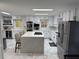 Modern kitchen featuring white cabinets, stainless steel appliances, and a large island with seating at 3320 Donegal Way, Snellville, GA 30039