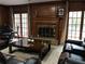 Cozy living room featuring a wooden fireplace, plush seating, and natural light from French doors at 3320 Donegal Way, Snellville, GA 30039