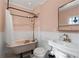 Pink bathroom with a vintage claw foot tub and modern fixtures at 1816 Williams Ave, East Point, GA 30344