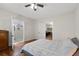 Bedroom featuring wood floors, access to an ensuite bathroom with a shower, and convenient entry to the kitchen at 1816 Williams Ave, East Point, GA 30344