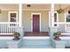 Close-up of a covered front porch with charming details and decorative flowerpots at 1816 Williams Ave, East Point, GA 30344
