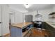 Bright kitchen features a functional island, modern appliances, granite counters and offers a seamless transition to other living areas at 1816 Williams Ave, East Point, GA 30344