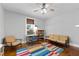 Bright living room with a ceiling fan, hardwood floors and lots of natural light at 1816 Williams Ave, East Point, GA 30344
