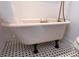 Bathroom featuring white claw foot tub with black accents at 1816 Williams Ave, East Point, GA 30344