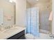 Cozy bathroom featuring a vanity with dark cabinets, a quartz countertop, and a shower and tub combo at 2289 Emerald Sky Dr, Smyrna, GA 30080