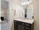 Bright bathroom featuring a vanity with dark cabinets, a quartz countertop, and a large mirror at 2289 Emerald Sky Dr, Smyrna, GA 30080