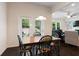 Bright dining area with a table and chairs set adjacent to the living room and backyard views at 2289 Emerald Sky Dr, Smyrna, GA 30080