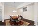 This dining room features a dark wood table and chairs, a chandelier, and a patterned rug at 2289 Emerald Sky Dr, Smyrna, GA 30080