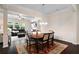 Elegant dining area with wainscoting opens to a cozy living room with fireplace and abundant natural light at 2289 Emerald Sky Dr, Smyrna, GA 30080
