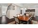 Open-concept dining area with dark wood table, modern chandelier, and easy access to the kitchen and living areas at 2289 Emerald Sky Dr, Smyrna, GA 30080
