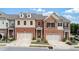 Charming townhome with brick and neutral siding, complemented by a two-car garage and well-maintained landscaping at 2289 Emerald Sky Dr, Smyrna, GA 30080
