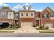 Charming townhomes with a mix of brick and siding, featuring well-kept landscaping and attached garages at 2289 Emerald Sky Dr, Smyrna, GA 30080