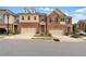 Attractive townhomes with brick and siding exteriors, manicured lawns, and two-car garages lining the street at 2289 Emerald Sky Dr, Smyrna, GA 30080