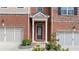 Charming townhome facade with brick and siding, featuring a well-manicured lawn and attached two-car garage at 2289 Emerald Sky Dr, Smyrna, GA 30080