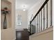Light-filled foyer featuring a staircase with iron railings and a view of the entryway and decor at 2289 Emerald Sky Dr, Smyrna, GA 30080