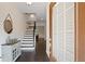 Inviting foyer with hardwood floors, staircase, decorative console table and ample natural light at 2289 Emerald Sky Dr, Smyrna, GA 30080