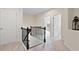 Hallway featuring dark wooden railings on the stairs and an entrance to a bedroom at 2289 Emerald Sky Dr, Smyrna, GA 30080