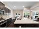 Modern kitchen boasts a large island, stainless steel appliances, and open floor plan to the living area at 2289 Emerald Sky Dr, Smyrna, GA 30080