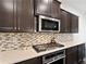 The gourmet kitchen features stainless steel appliances, a tile backsplash, and sleek countertops at 2289 Emerald Sky Dr, Smyrna, GA 30080