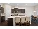 Eat-in kitchen with stainless steel appliances, a breakfast bar, and dark cabinets at 2289 Emerald Sky Dr, Smyrna, GA 30080