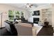 Bright living room with large windows, a ceiling fan, and a fireplace with built-in bookshelves at 2289 Emerald Sky Dr, Smyrna, GA 30080