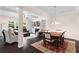 Spacious living room with fireplace, built-in shelving, and ample natural light next to formal dining space at 2289 Emerald Sky Dr, Smyrna, GA 30080